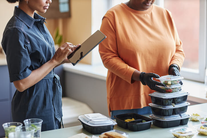 A food and nutrition management professional overseeing meal services in a healthcare facility