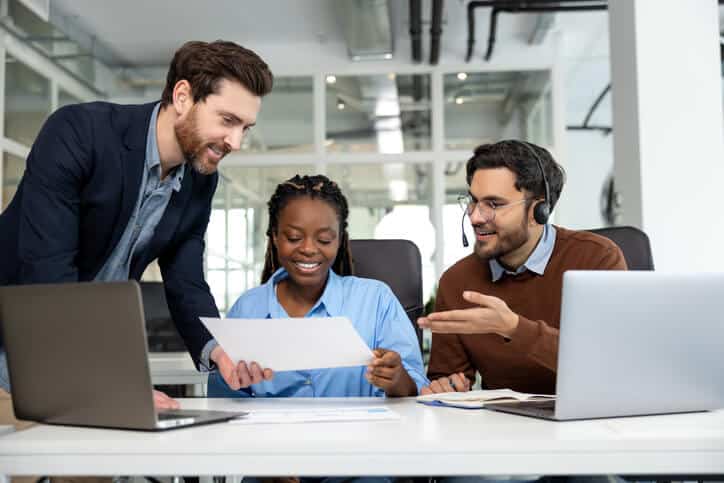 A team of IT support certificate graduates analyzing ticket triage steps in a help desk workflow