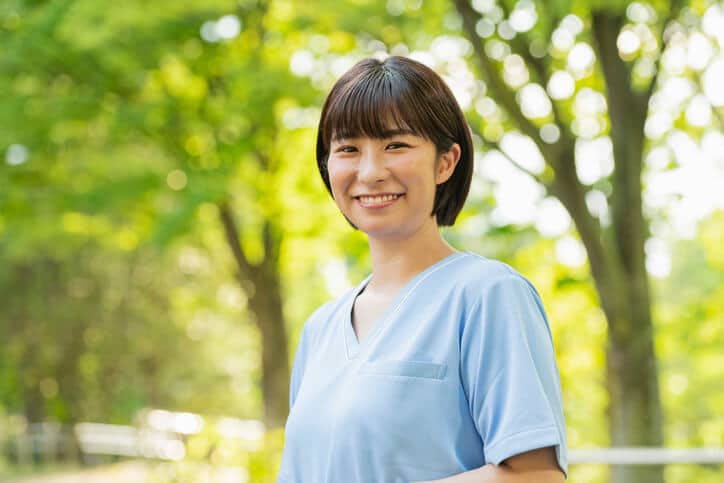 A smiling female personal support worker at a care home after completing her personal support worker certificate program