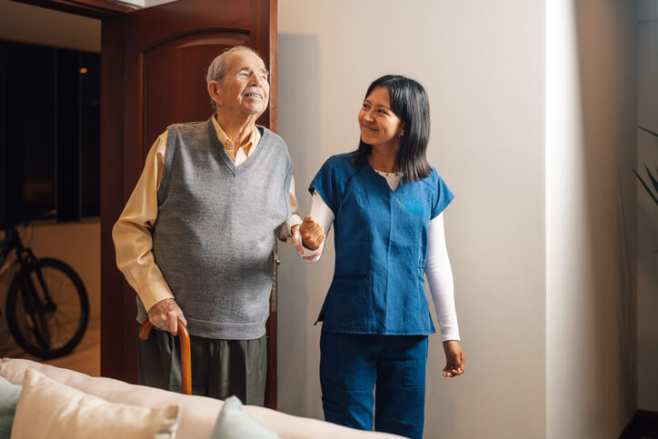 A Personal Support Worker Certificate holder assisting a resident during daily care