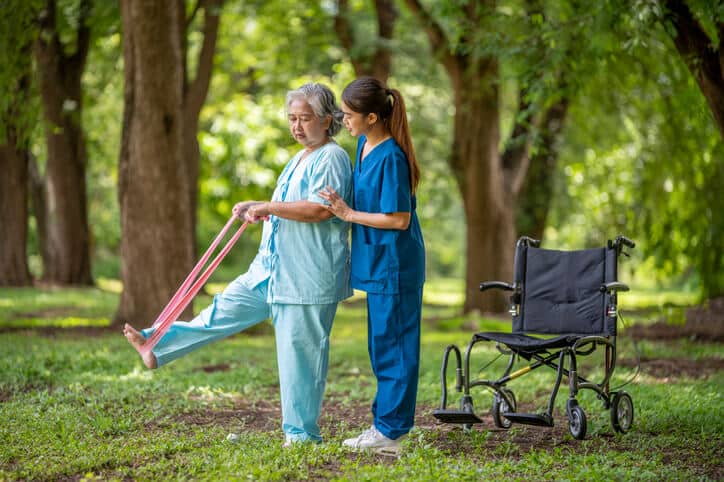 A PSW helping a patient with mobility exercises