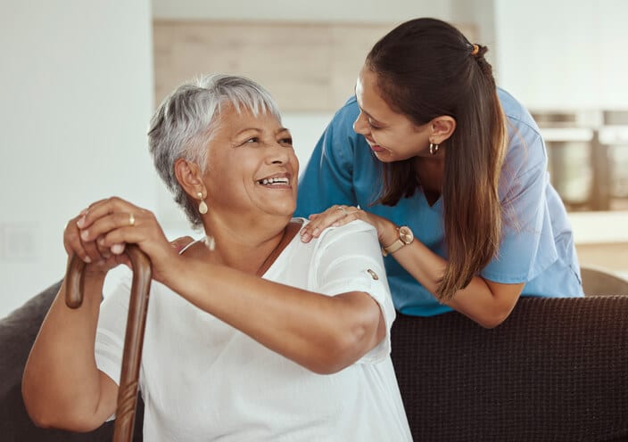 A Friendly and personable personal support worker interacting with a happy client