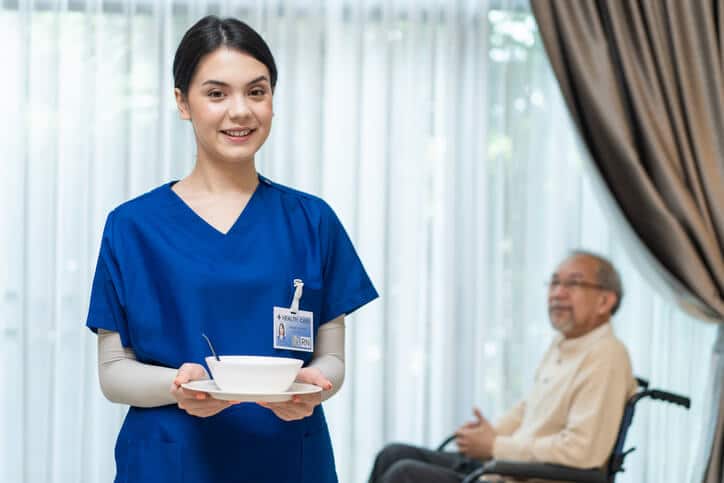 A personal support worker providing care in a long-term facility