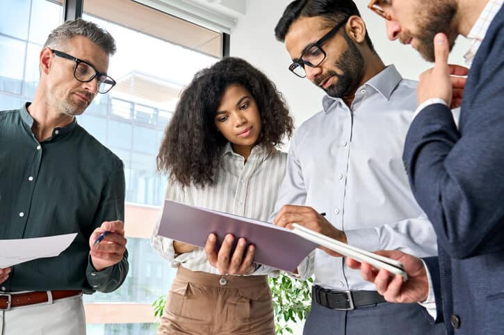 A Quality Assurance and Quality Control Diploma graduate team reviewing change control documentation