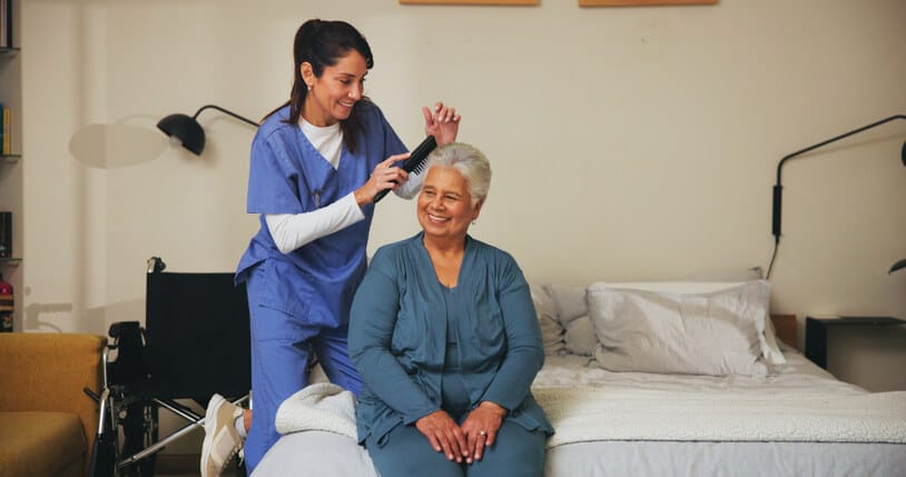 A personal support worker assisting a senior at home
