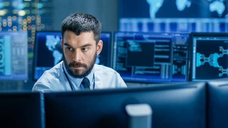 A cybersecurity analyst performing SOC alert triage at a workstation