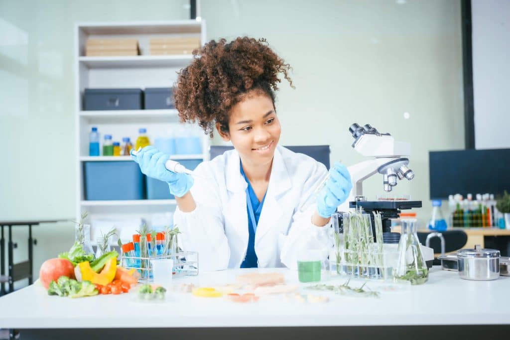 Student learning food analytical laboratory skills using microbiology testing equipment
