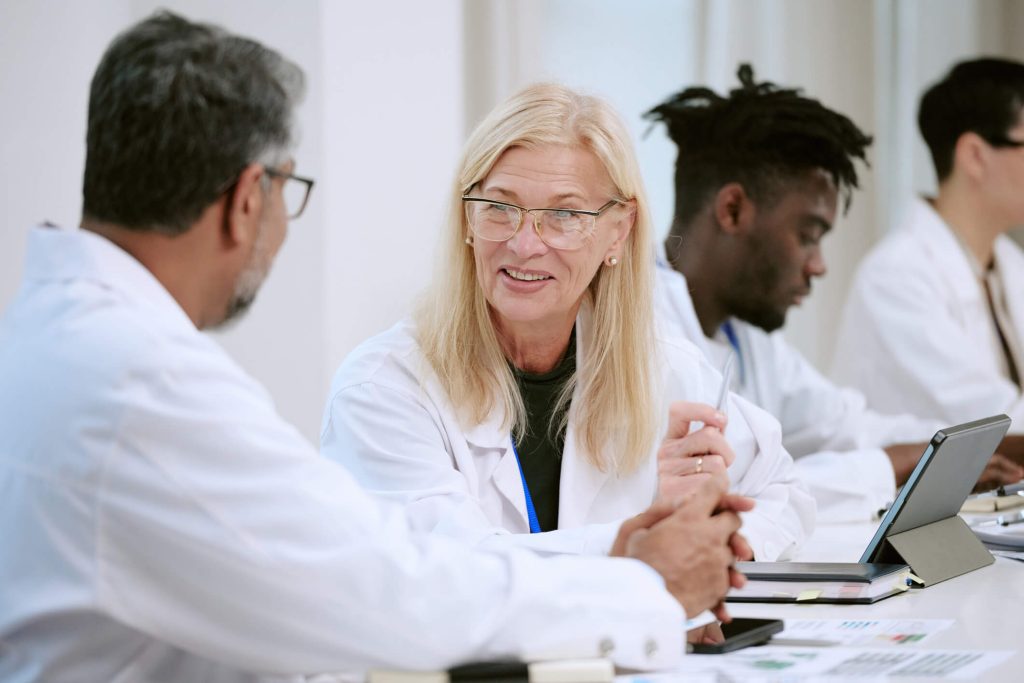 Clinical research monitor meeting with investigators during a clinical trial