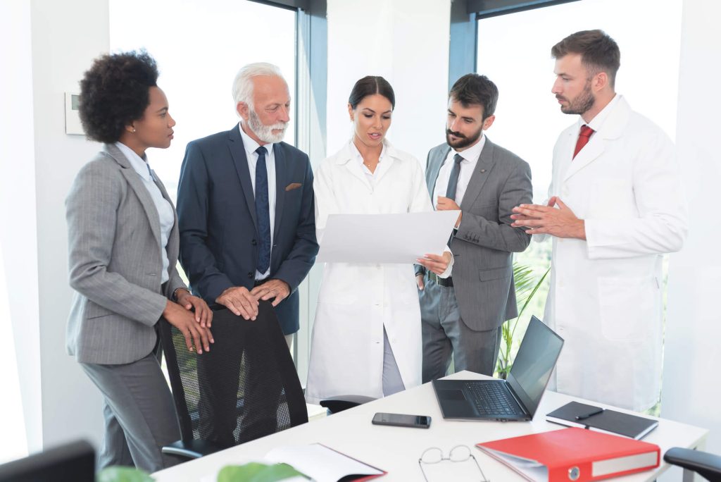 A research team discussing a clinical monitoring plan before a site visit