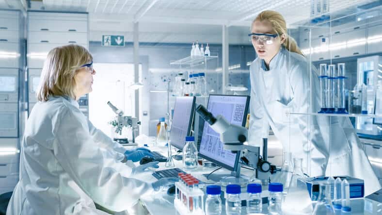 A research team monitoring clinical trial data in a laboratory