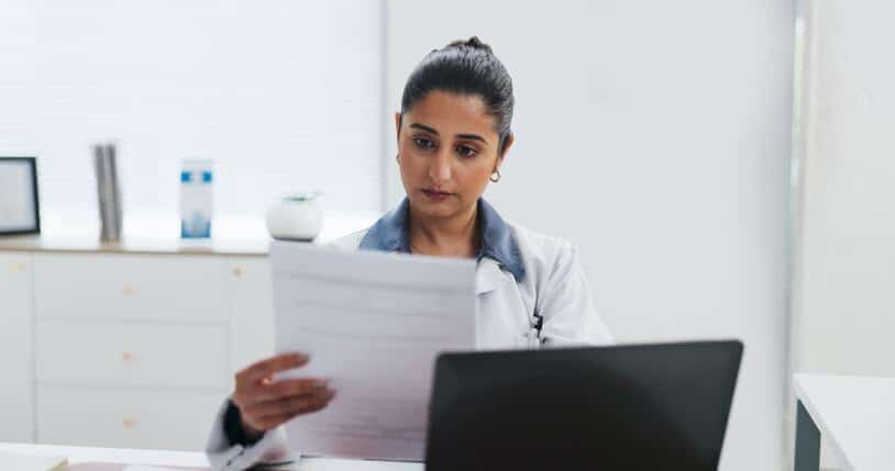 A clinical research certificate graduate reviewing adverse event documentation