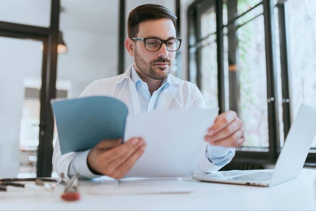 pharmacovigilance specialist reviewing adverse drug reaction reports