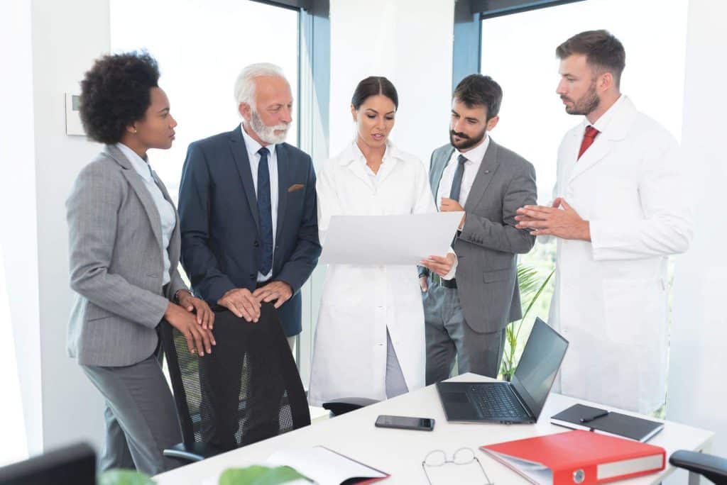 Clinical research associate reviewing study documents with site staff