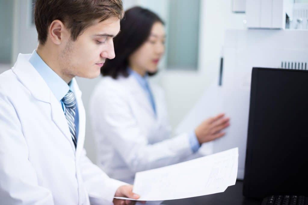 Students reviewing essential clinical trial documents during research training