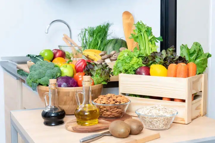 A bunch of fresh fruits, vegetables, and whole grains on a kitchen counter as explored in the Food and Nutrition Management Program