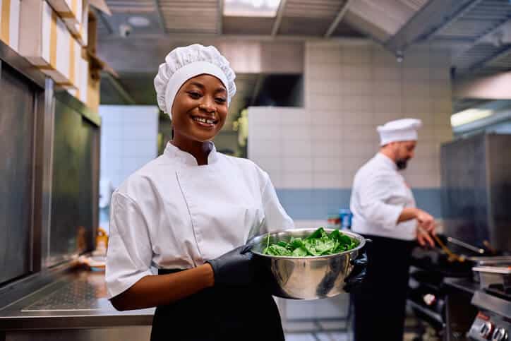 A food service staff member preparing meals for nursing home residents as part of their food and nutrition training