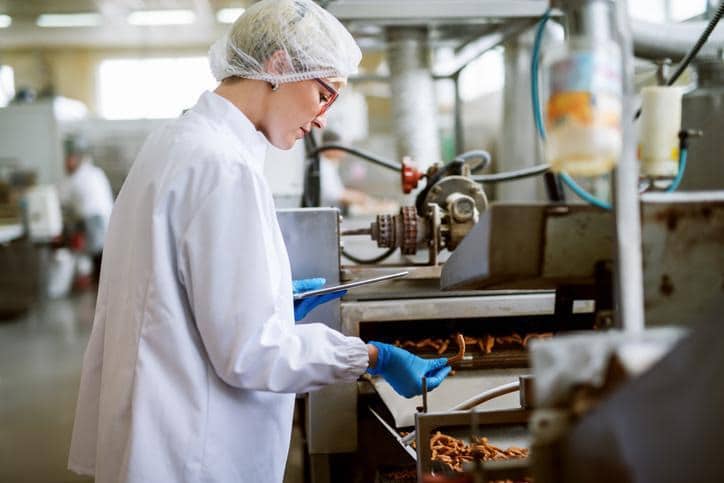 An AAPS student learning food processing sanitation procedures