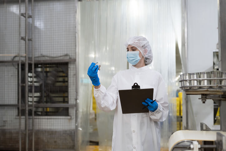 A quality assurance specialist conducting a sanitation audit in a food facility