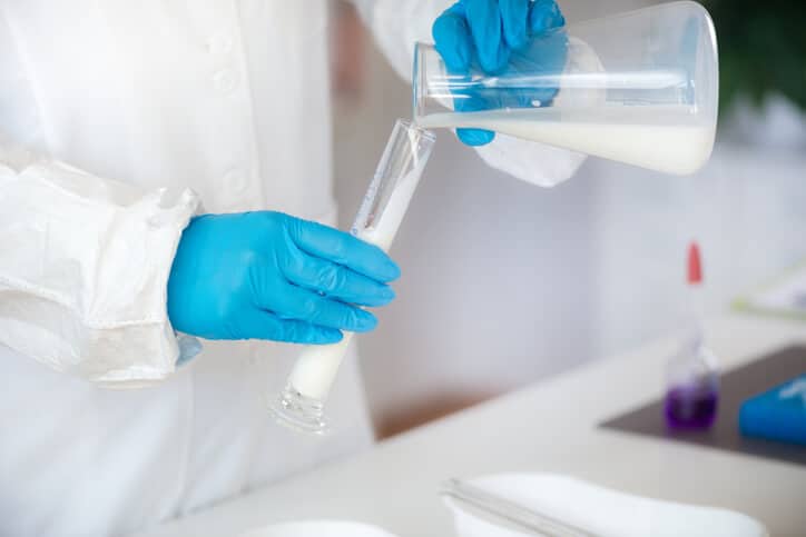 A glass beaker of beneficial microbes to be examined in food safety training