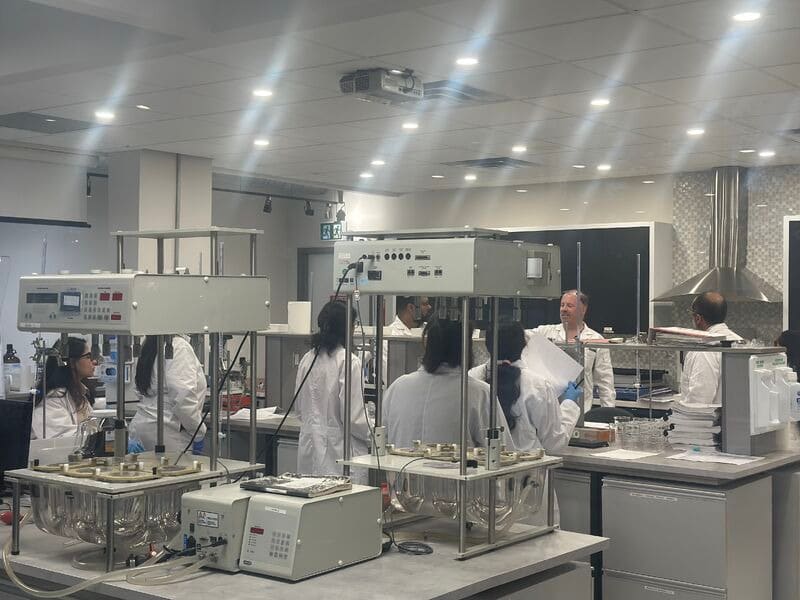 An AAPS College learner completing documentation during GMP training in pharmaceutical quality