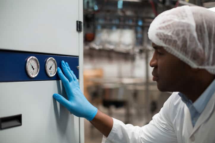 Quality assurance professional checking temperature data at a critical control point