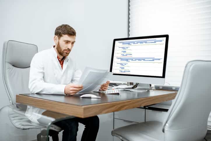 A clinical research coordinator checks protocol procedures and visit schedules
