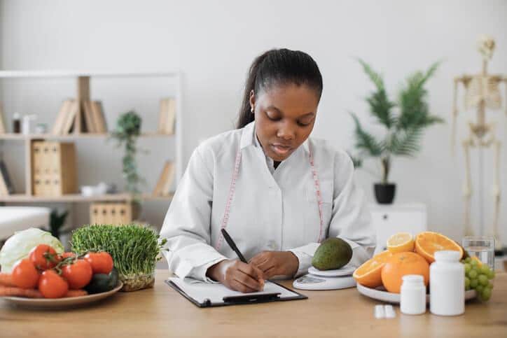 A healthcare professional planning a balanced meal for a patient's recovery