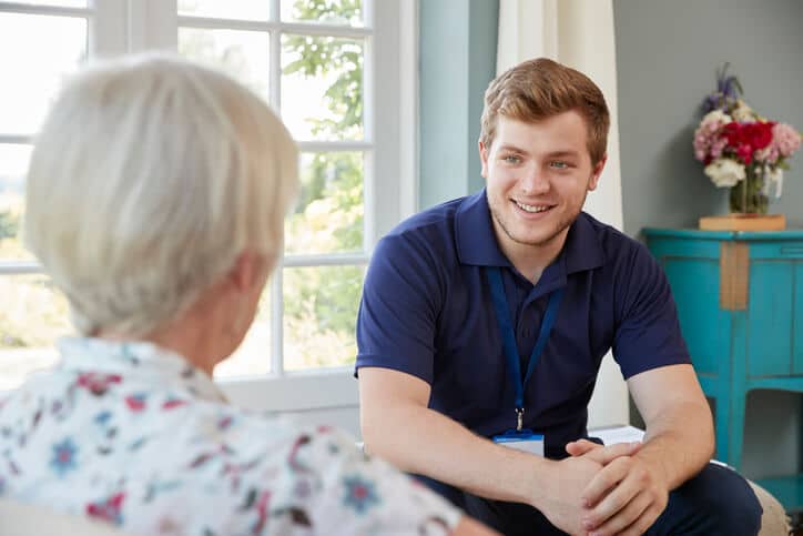 A personal support worker calmly communicating with a resident