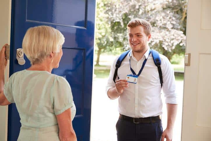 A smiling male Personal support worker showing up at a client's home