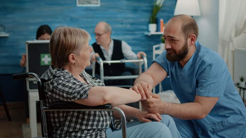 A PSW using de-escalation techniques in a long-term care setting