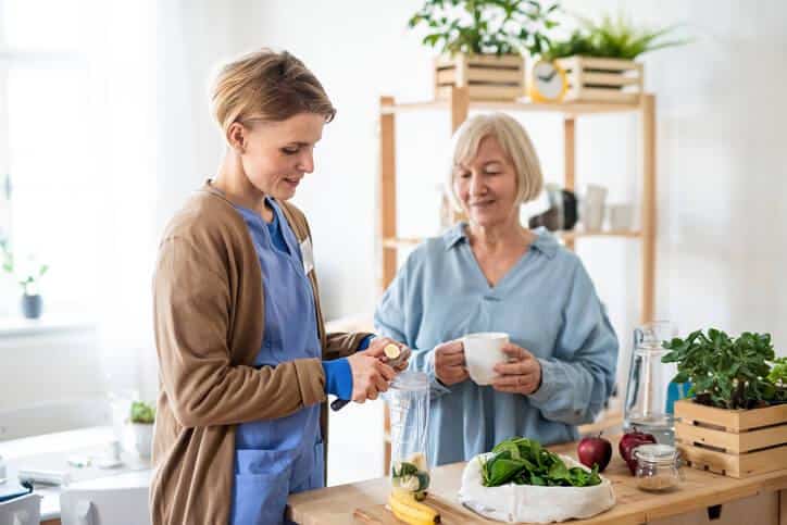 A PSW helping an elderly woman with daily activities