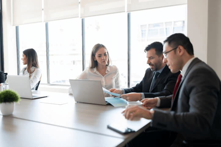 A team of regulatory affairs specialists collaborating on compliance strategy in a meeting room