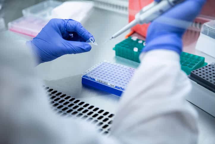 A pharmaceutical professional holding a test sample in the laboratory after pharmaceutical training