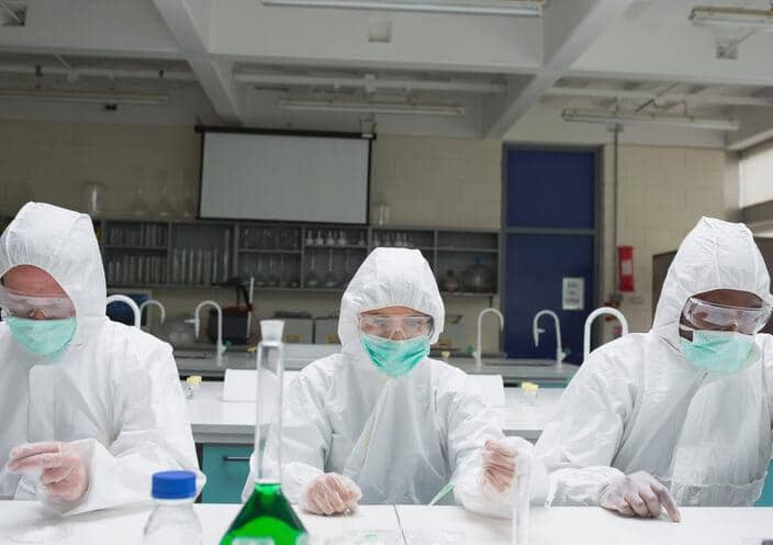 A row of students wearing PPE during pharmaceutical quality assurance training