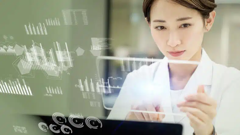 A pharma professional analyzing AI-driven data in a drug development lab