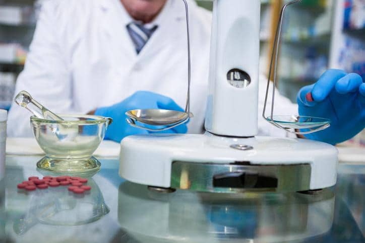 Pharmaceutical analyst performing stability testing in a laboratory