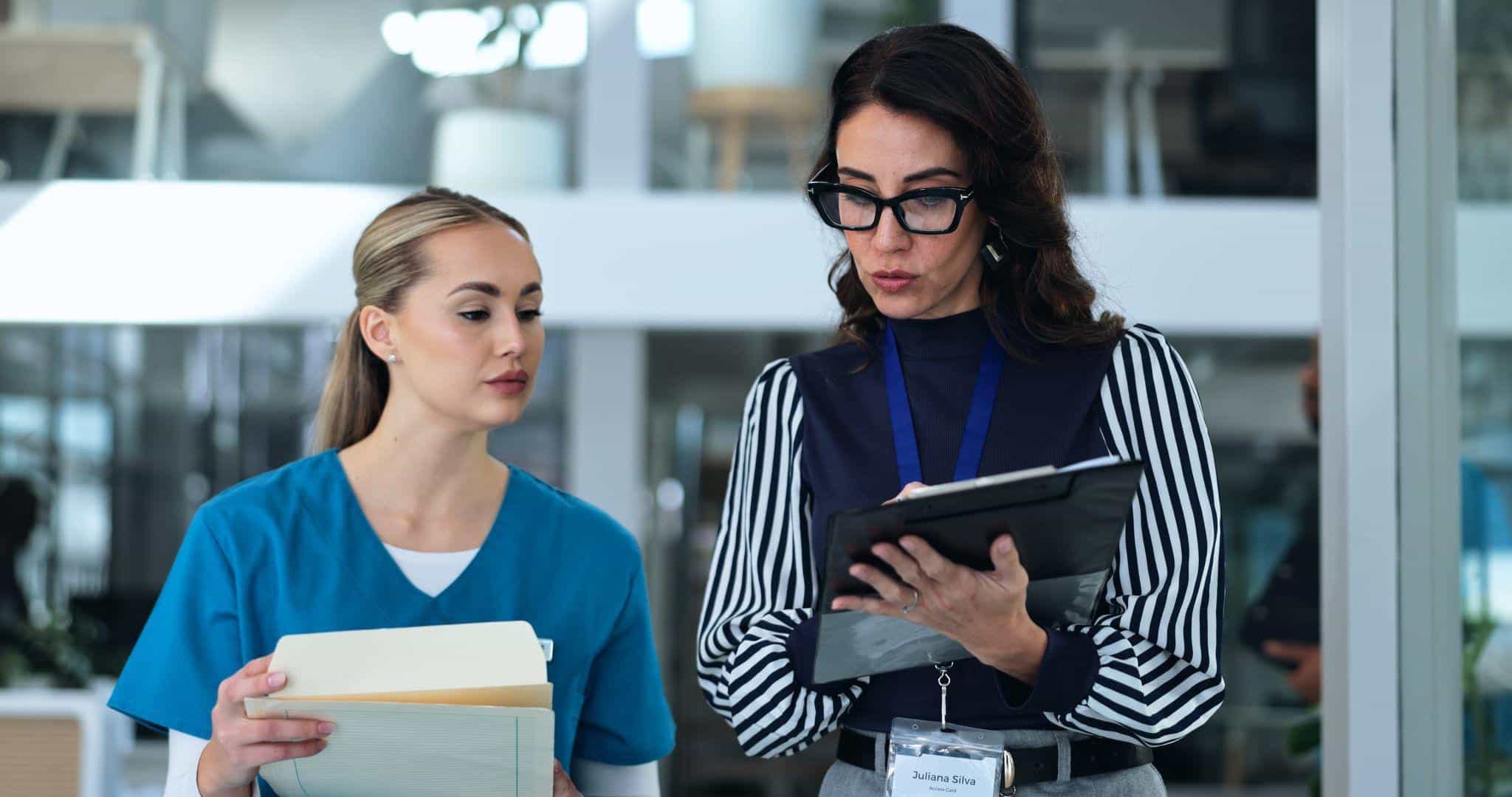 A clinical research coordinator reviewing a study protocol and participant visit records