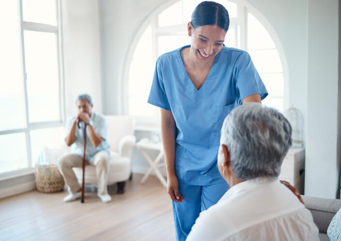 A personal Support Worker assisting a senior in a long-term care facility