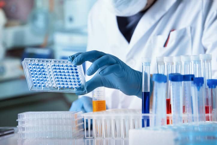 A quality control analyst performing laboratory testing on pharmaceutical samples