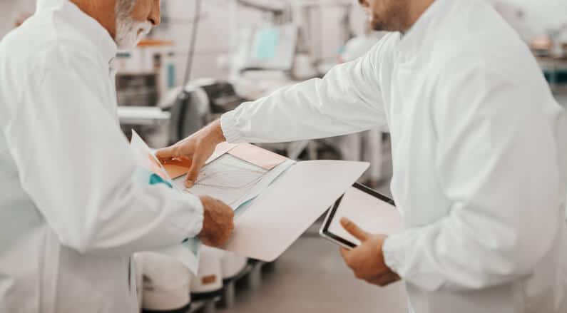A pharmaceutical quality team reviewing documentation before approving a manufacturing batch