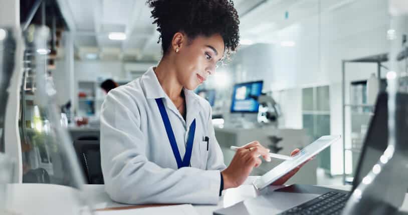 Focused female document reviewer at work after completing her pharma QA training