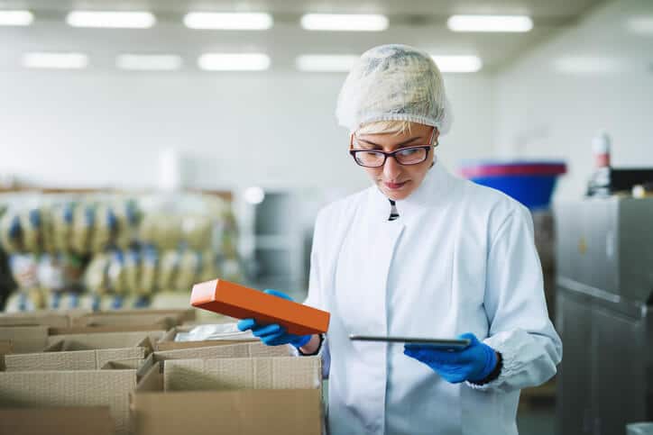 A quality assurance specialist reviewing recall documentation in food manufacturing