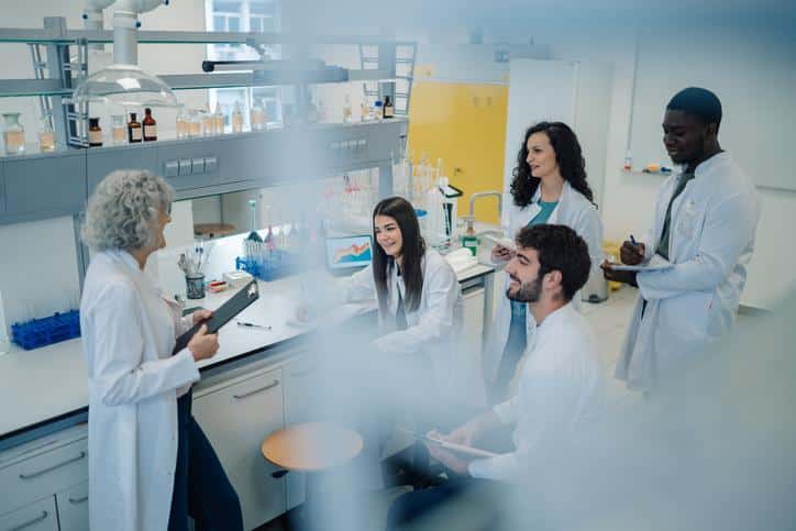 Students discussing laboratory results during research and development training